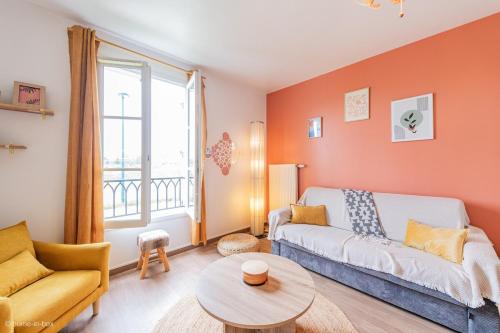 a living room with a couch and a table at Le Rangiroa, 4 people, 5 min to Disneyland Paris in Marne-la-Vallée