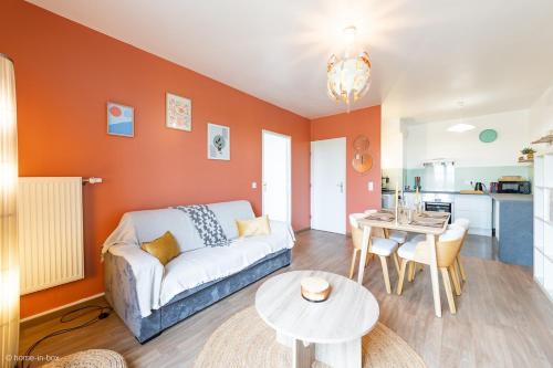 a living room with a couch and a table at Le Rangiroa, 4 people, 5 min to Disneyland Paris in Marne-la-Vallée