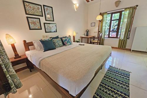 a bedroom with a large bed in a room at Inn Pondiville Forest Retreat in Puducherry