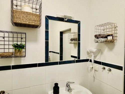 a bathroom with a mirror and a sink at AyCatcherHomes - Top Lage I 4 Personen I 2 Schlafzimmer I Zentral I Altstadt Marburg I Nähe Fluss Lahn I WLAN I Boutique App CHIRON in Marburg an der Lahn