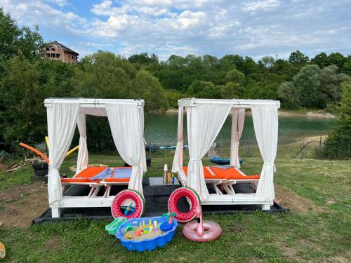 a group of beds with toys in the grass at Cozy Lake House in Cinciş
