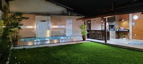 a pool in the middle of a house with a yard at Casa de praia completa em Mucuri BA in Mucuri