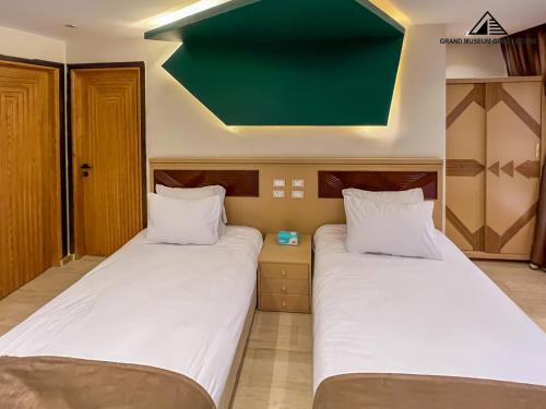 two beds sitting next to each other in a room at grand museum view hotel in Cairo