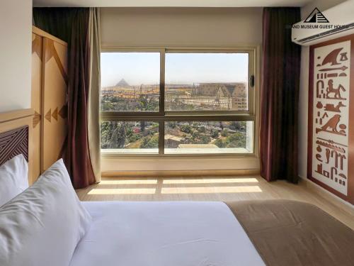 a bedroom with a bed and a large window at grand museum view hotel in Cairo