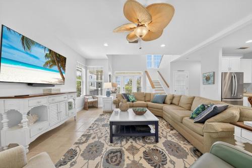 a living room with a couch and a flat screen tv at Sea Oats Oasis in Sanibel
