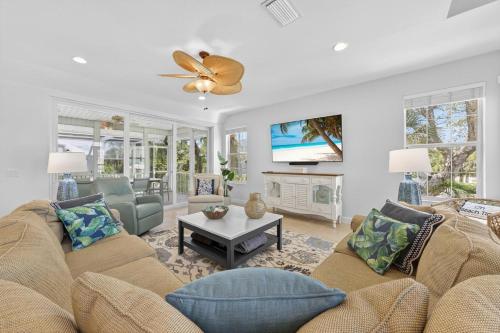 a living room with a couch and a tv at Sea Oats Oasis in Sanibel