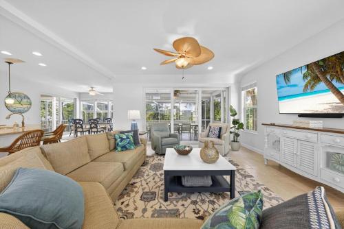 a living room with a couch and a tv at Sea Oats Oasis in Sanibel