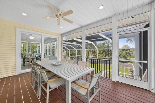a dining room with a table and chairs on a deck at Sea Oats Oasis in Sanibel