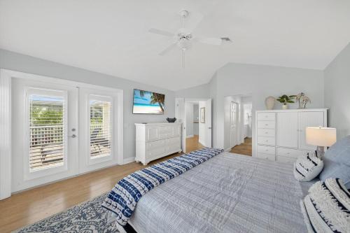 a white bedroom with a bed and a couch at Sea Oats Oasis in Sanibel