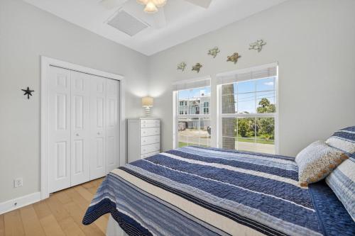 a white bedroom with a bed and a window at Sea Oats Oasis in Sanibel