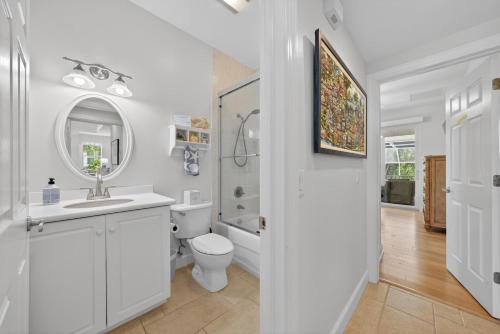 a white bathroom with a sink and a toilet at Sea Oats Oasis in Sanibel
