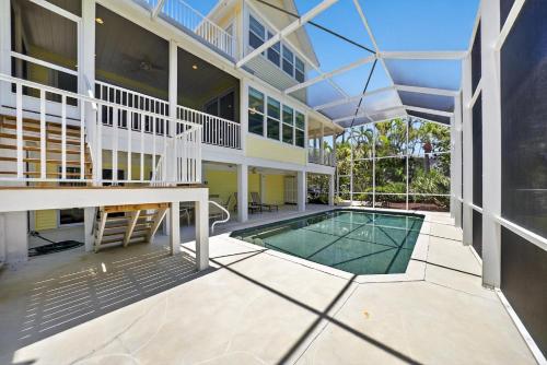 an exterior view of a house with a swimming pool at Sea Oats Oasis in Sanibel