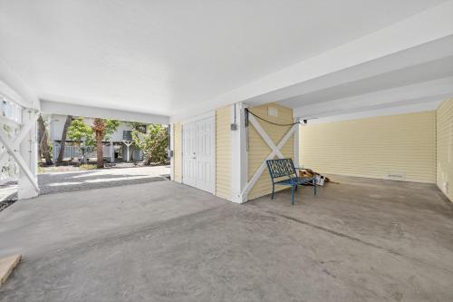an empty garage with a blue chair sitting on a patio at Sea Oats Oasis in Sanibel