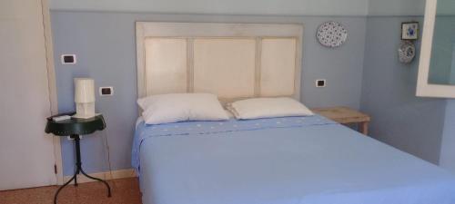 a blue bedroom with a bed with two white pillows at Casa Mia in San Benedetto del Tronto