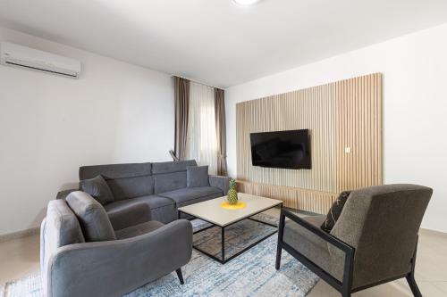 a living room with a couch and two chairs and a table at Vertmont Villa in Sveti Stefan