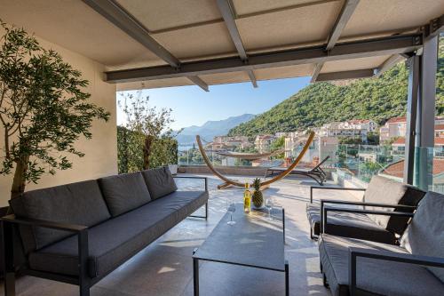a living room with a couch and a table at Vertmont Villa in Sveti Stefan