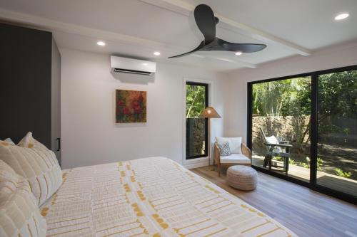 a bedroom with a bed and a ceiling fan at Hui Pu in Waikoloa