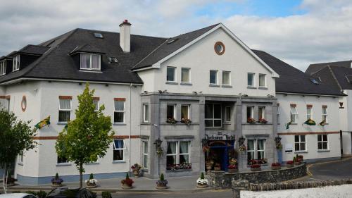 a large white building with a black roof at Jackson's Hotel & Leisure Centre in Ballybofey