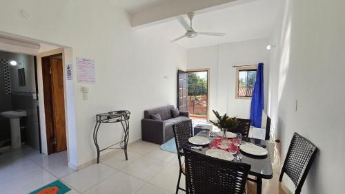 a living room with a table and a couch at JG&A Home in Itauguá