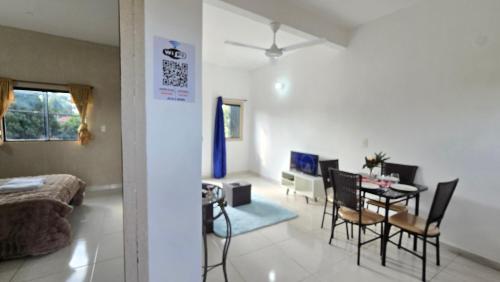 a living room and dining room with a table and chairs at JG&A Home in Itauguá