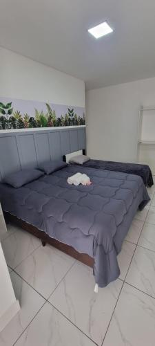 a large blue bed in a room with plants at Iguassu Jungle Hotel pousada in Foz do Iguaçu