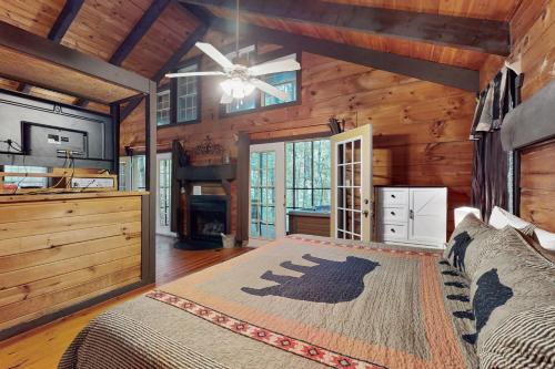 a bedroom with a bed and a fireplace in a cabin at Idlewild in Sautee Nacoochee