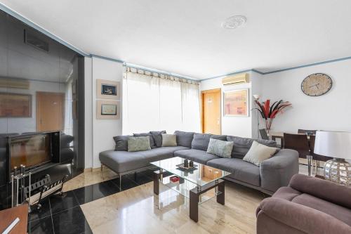 a living room with a couch and a tv at Finca Pozoblanco with private pool 