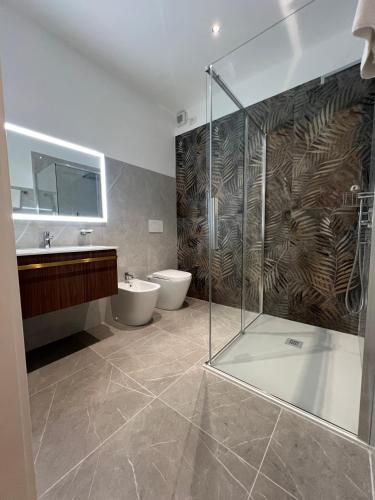 a bathroom with a shower and a toilet and a sink at Amo Venice in Venice