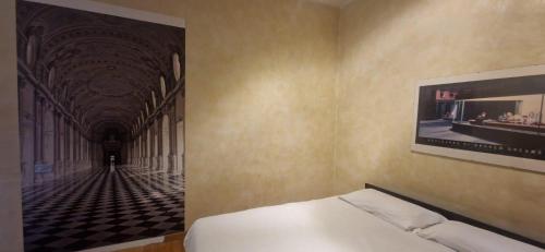 a bedroom with a bed and a picture of a hallway at MARCONI TURIN Loft, studio nei pressi di Porta Nuova in Turin