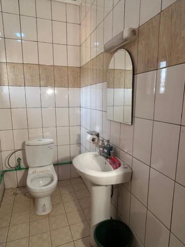 a bathroom with a toilet and a sink at Prodiges Hôtel in Yaoundé