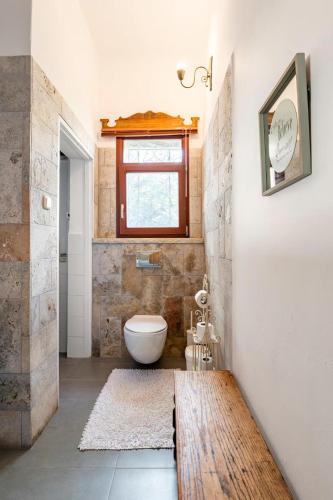 a bathroom with a toilet and a window at Quiet and Spacious Luxury Apartment with Splendid View between Carmel and Downtown in Haifa