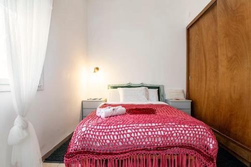 a bedroom with a bed with a red blanket on it at Quiet and Spacious Luxury Apartment with Splendid View between Carmel and Downtown in Haifa