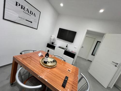 a room with a table with a bottle of wine on it at Rosa Bianca apartment - Free Parking in the historic center of Alba - Langhe in Alba