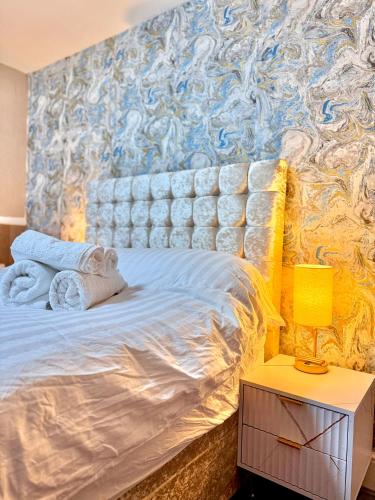 a bedroom with a bed with a blue and yellow wall at Full Home with Free Parking in Moss Bank, Crumpsall, Manchester in Manchester