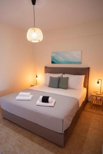 a bedroom with a large bed with two towels on it at Drosia Apartments in Lefkandi in Lefkandi Chalkidas