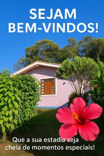 a poster for a house with a pink flower at Recanto Duas Rosas in Venda Nova do Imigrante