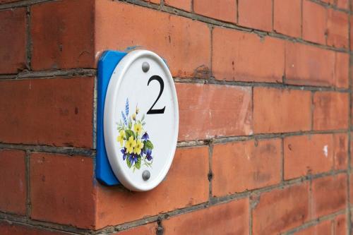 a clock on a brick wall with the number two at Vas's York House in York