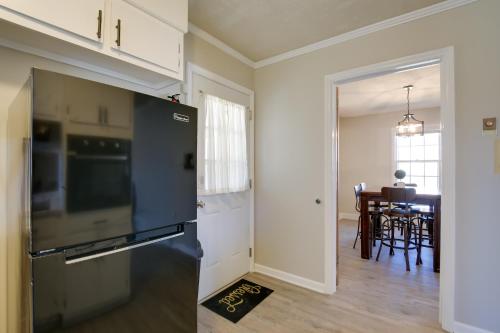 a kitchen with a black refrigerator and a dining room at Pet-Friendly Easley Family House with Game Room in Easley