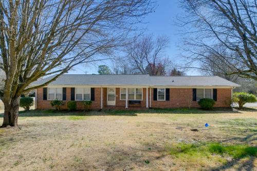 a brick house with a tree in a yard at Pet-Friendly Easley Family House with Game Room in Easley