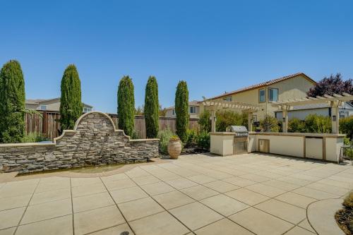a yard with a stone fountain and a house at Patio and Outdoor Kitchen Manteca Family Home in Manteca