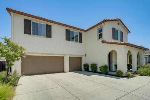 a house with a large driveway in front of it at Patio and Outdoor Kitchen Manteca Family Home in Manteca