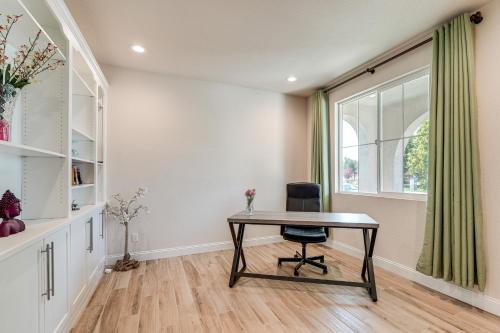 a desk with a chair in a room with a window at Patio and Outdoor Kitchen Manteca Family Home in Manteca