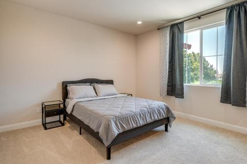 a bedroom with a bed and a window at Patio and Outdoor Kitchen Manteca Family Home in Manteca