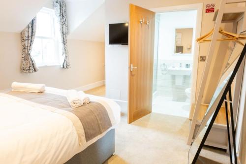 a bedroom with a bed and a bathroom at The Barmouth Bar & Grill in Barmouth