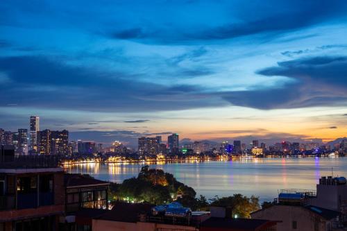 a view of a city skyline at night at Azen Lakeside Hotel & Travel in Hanoi