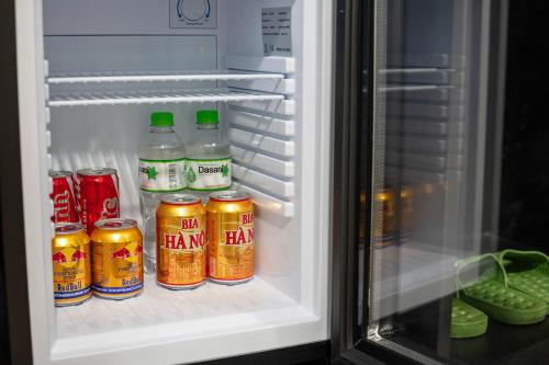 an open refrigerator filled with cans of hawai at Azen Lakeside Hotel & Travel in Hanoi