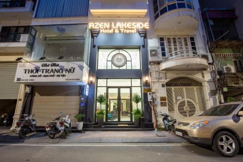 a car parked in front of a building at Azen Lakeside Hotel & Travel in Hanoi