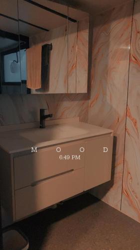 a bathroom with a sink and a mirror at Sfparadise in Salalah