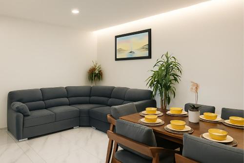 a living room with a couch and a table at Sunset Suites Mazatlán at Lomas de Mazatlán in Mazatlán