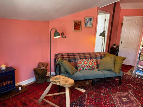 a living room with a couch and a table at 8b The Bookcase in Dawlish